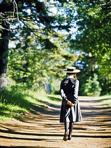 A young girl strolls down a country road